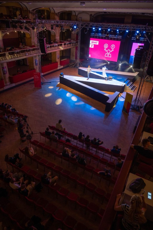 View from the balcony of Phil presenting at WebExpo to a seated audience